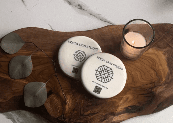 Two white plates sitting on top of a wooden board.